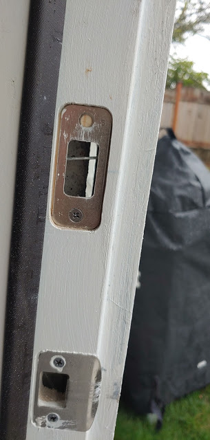 a deadbolt strike with a nail blocking it