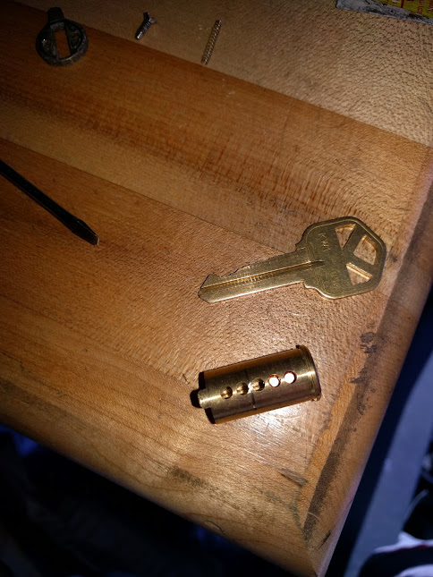 An incompetent locksmith dropped all but two pins in this lock cylinder. Also note the key which looks like it was cut by a drunk blind person.